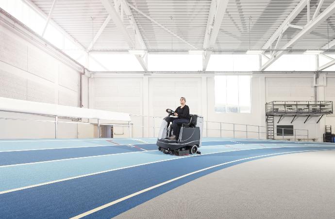 Industrial cleaning machine maintaining the floor of an indoor entertainment facility.